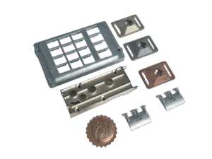 A set of precision zinc die casting parts—including inserts, housings, and decorative emblems—arranged on a white background.