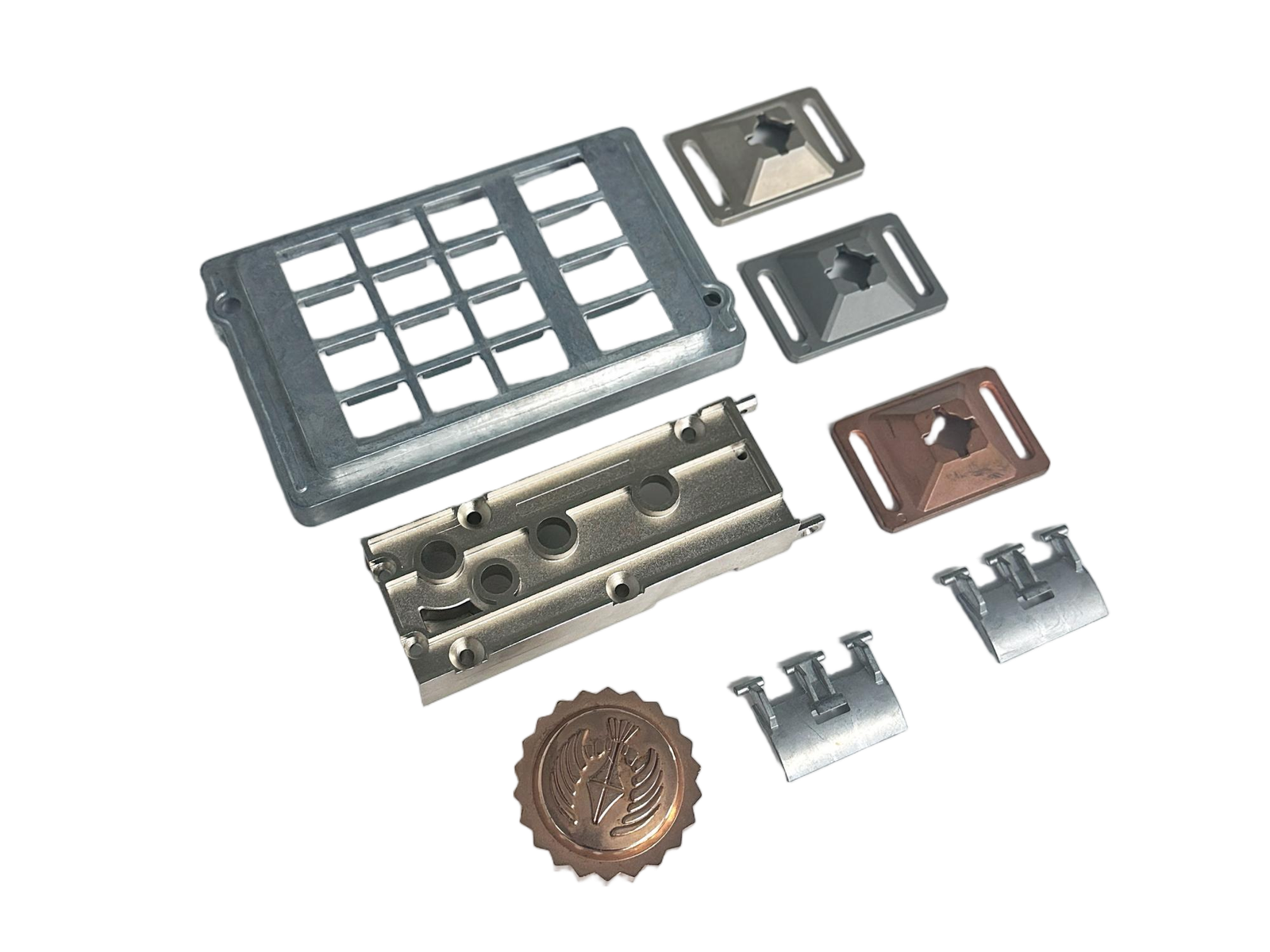A set of precision zinc die casting parts—including inserts, housings, and decorative emblems—arranged on a white background.