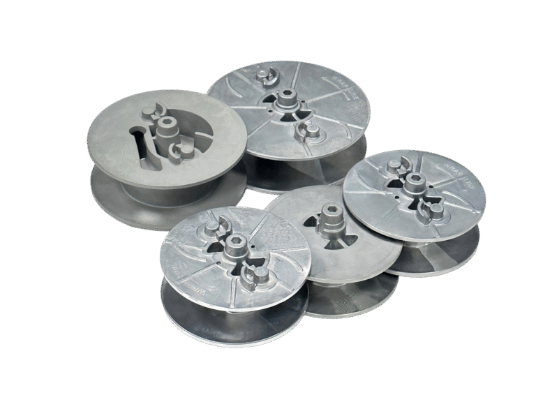 A set of round, disc-shaped metal prototypes arranged on a white background.