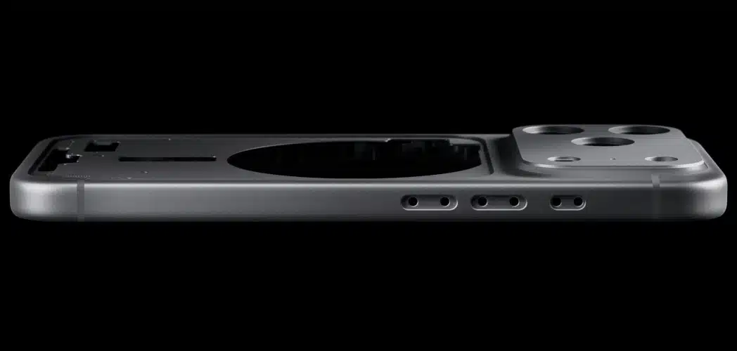 Side profile of an iPhone 17 Pro unibody aluminum shell showing camera island, speaker holes, and precision-machined edges against a black background.