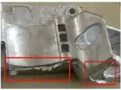 Aluminum die casting flash/burr along the parting line—thin fins of excess metal at edges.