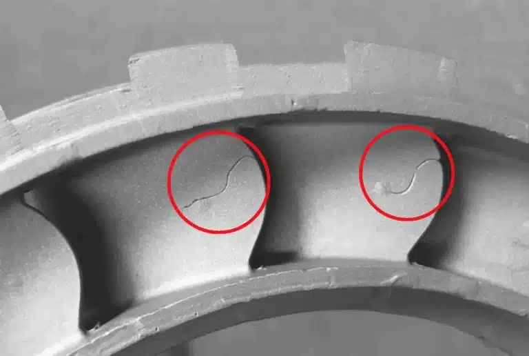Crack-like cold shut lines on an aluminum die casting, highlighted in red