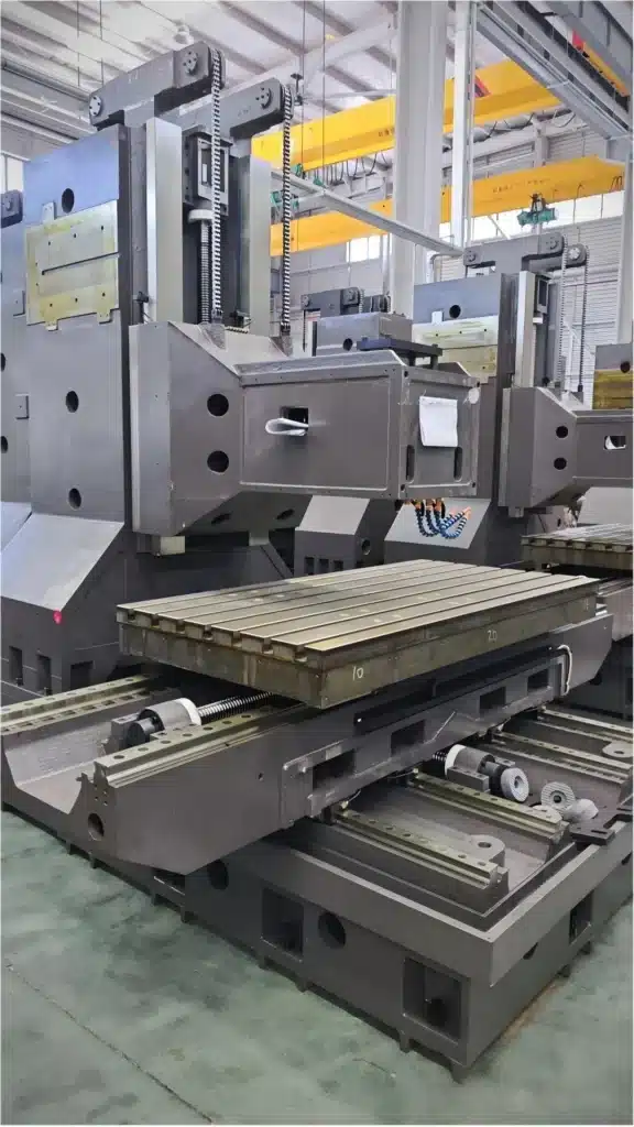 Three-axis CNC machine structure with linear guideways, box ways, ball screws, and worktable