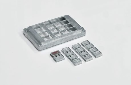 ATM keypad with aluminum housing and zinc alloy keys arranged for production inspection.
