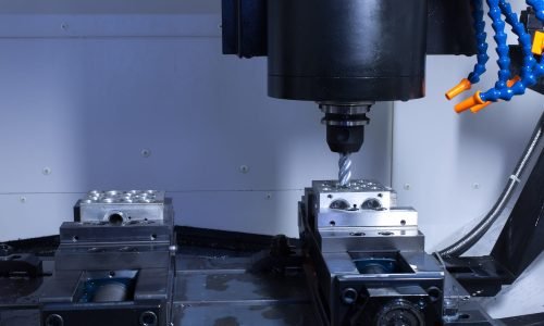 CNC machining equipment performing high-precision milling on a metal part at Cast-Mold’s facility.