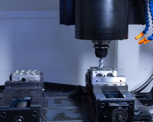 CNC machining equipment performing high-precision milling on a metal part at Cast-Mold’s facility.