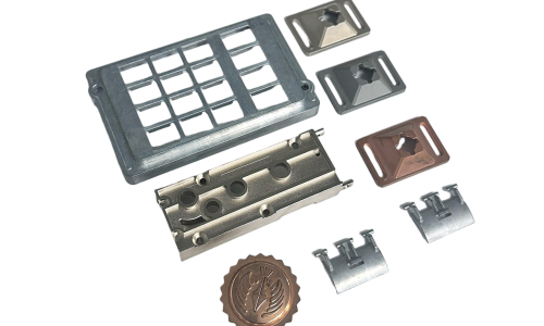 A set of precision zinc die casting parts—including inserts, housings, and decorative emblems—arranged on a white background.