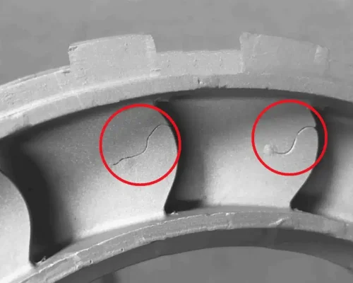 Crack-like cold shut lines on an aluminum die casting, highlighted in red