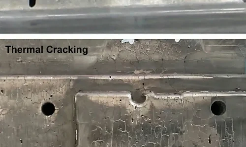 High pressure die casting mold steel surface showing cavitation pits near the gate and severe thermal cracking in the cavity region.