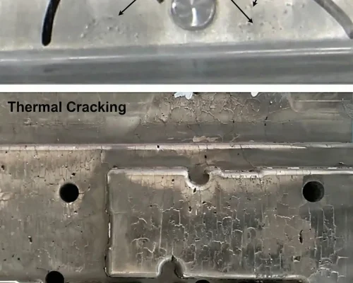 High pressure die casting mold steel surface showing cavitation pits near the gate and severe thermal cracking in the cavity region.
